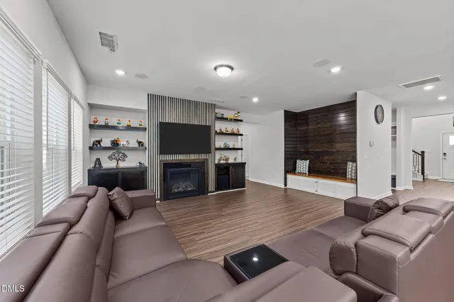 a spacious bedroom with a bed dresser and a window