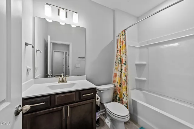 a spacious bathroom with a double vanity sink a large mirror and shower