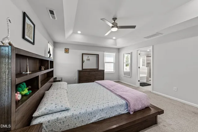 a bedroom with a bed and a ceiling fan