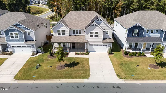an aerial view of a house with yard