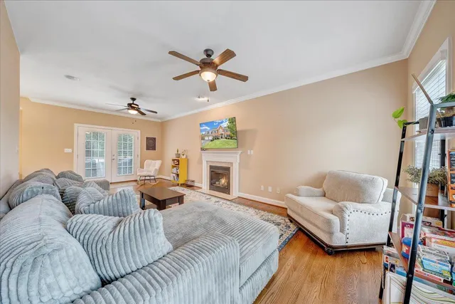 a living room with furniture and a wooden floor