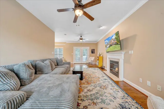 a living room with furniture and a wooden floor