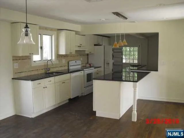 a kitchen with stainless steel appliances a sink and a microwave