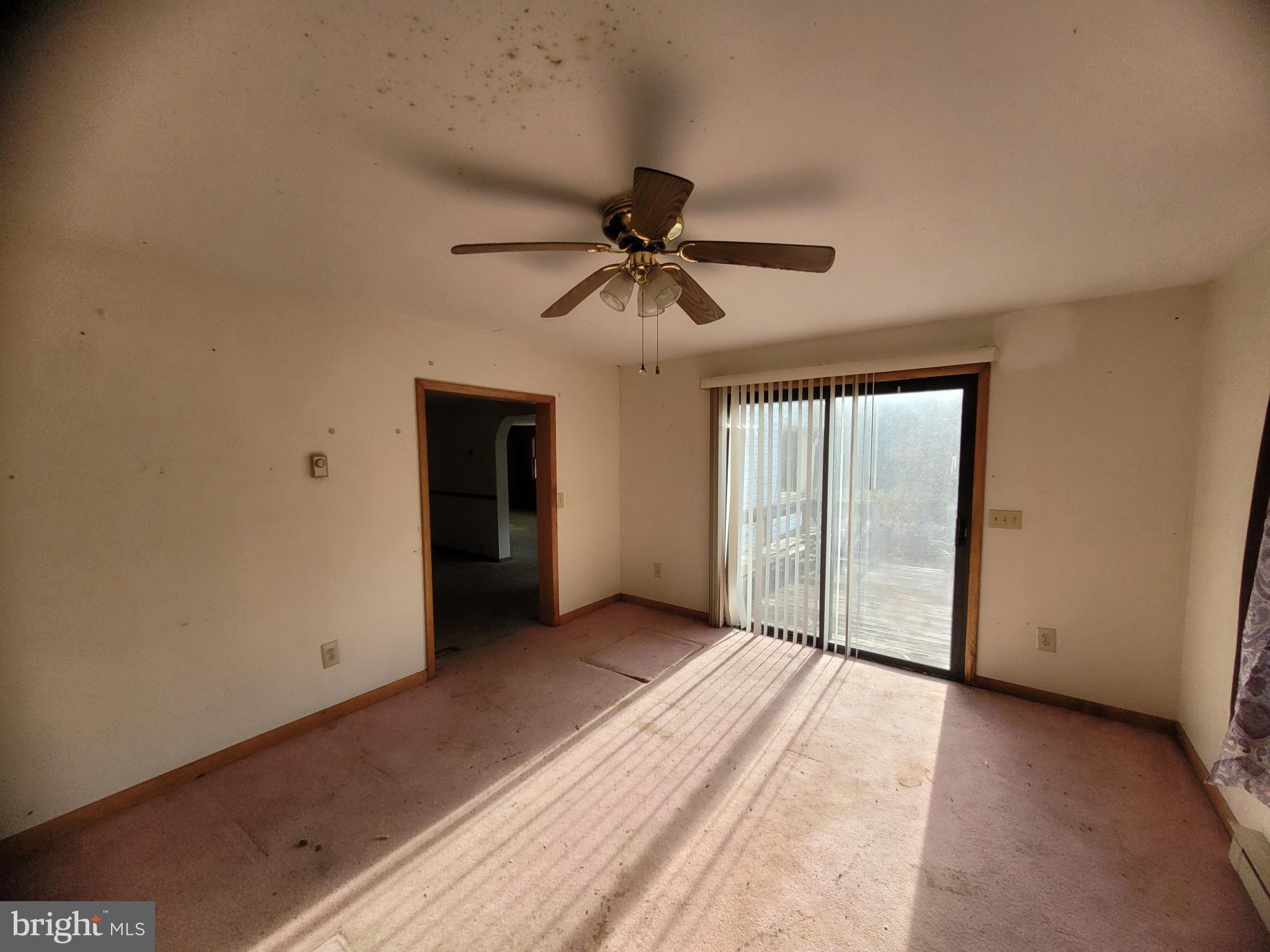 9492 Cumberland Road Springfield, WV 26763 - Photo 14 of 33 a view of a livingroom with a ceiling fan and window