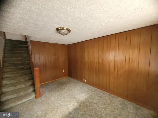 a view of an empty room with wooden walls