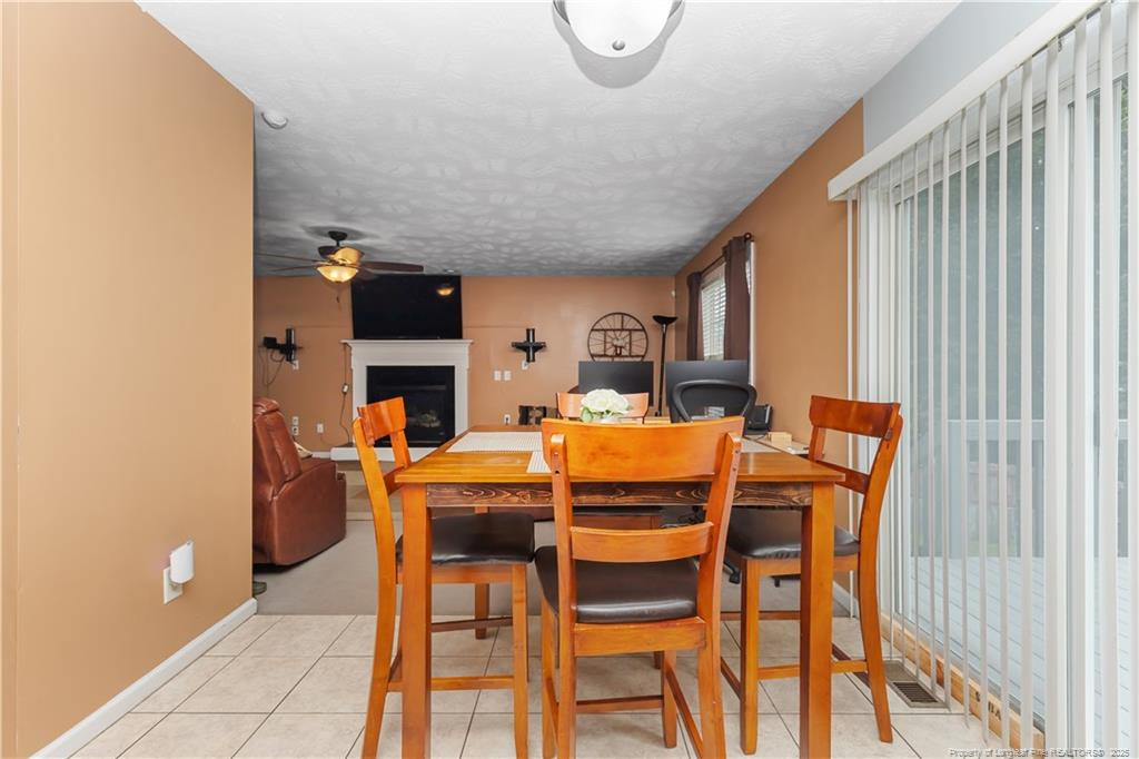 121 Jubilee Court Cameron, NC 28326 - Photo 12 of 36 a dining room with furniture and a fireplace