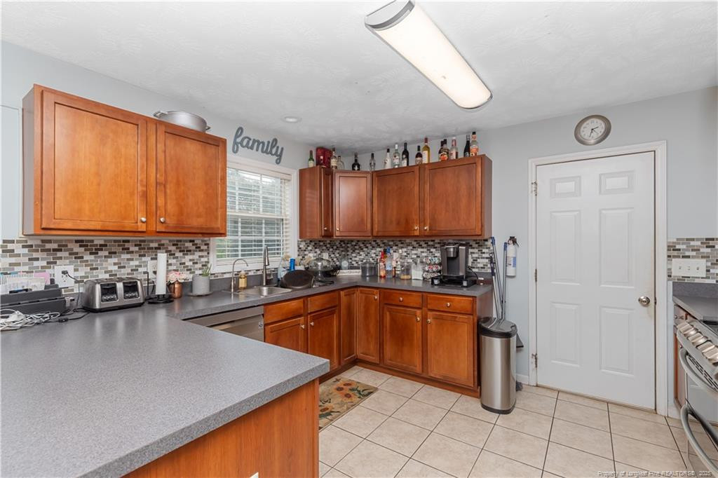121 Jubilee Court Cameron, NC 28326 - Photo 14 of 36 a kitchen with stainless steel appliances granite countertop a sink a stove and a microwave