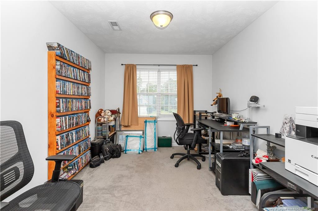 121 Jubilee Court Cameron, NC 28326 - Photo 17 of 36 a view of a workspace with furniture and a window