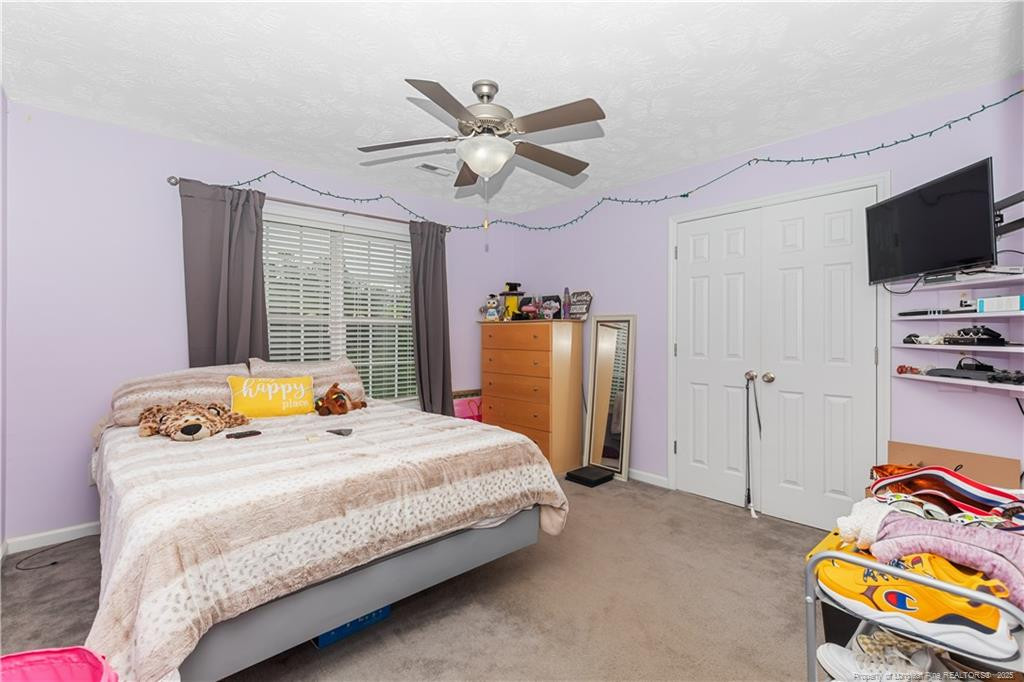 121 Jubilee Court Cameron, NC 28326 - Photo 18 of 36 a bedroom with a bed and flat tv