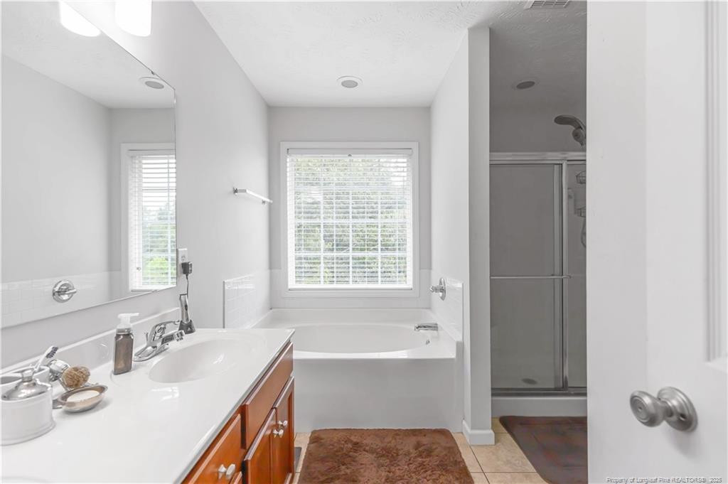 121 Jubilee Court Cameron, NC 28326 - Photo 29 of 36 a bathroom with a tub sink and mirror
