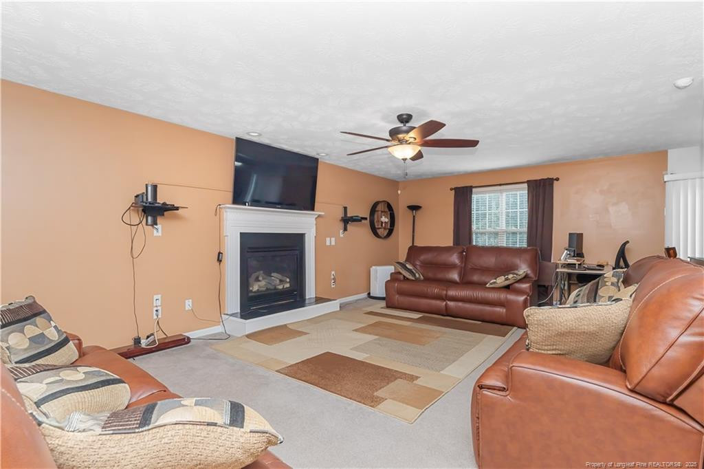 121 Jubilee Court Cameron, NC 28326 - Photo 9 of 36 a living room with furniture and a fireplace