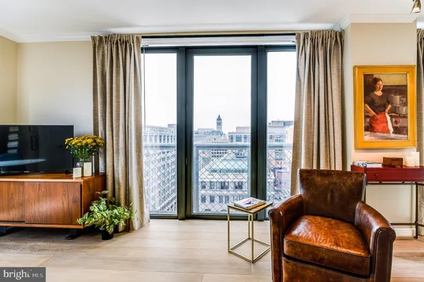 a living room with furniture and a floor to ceiling window