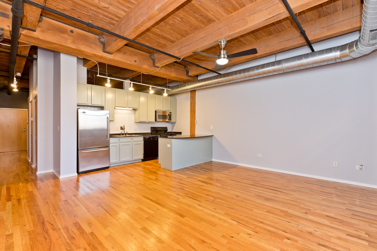 1500 West Monroe Street, Unit 515 Chicago, IL 60607 - Photo 3 of 10 a view of a kitchen with wooden floor