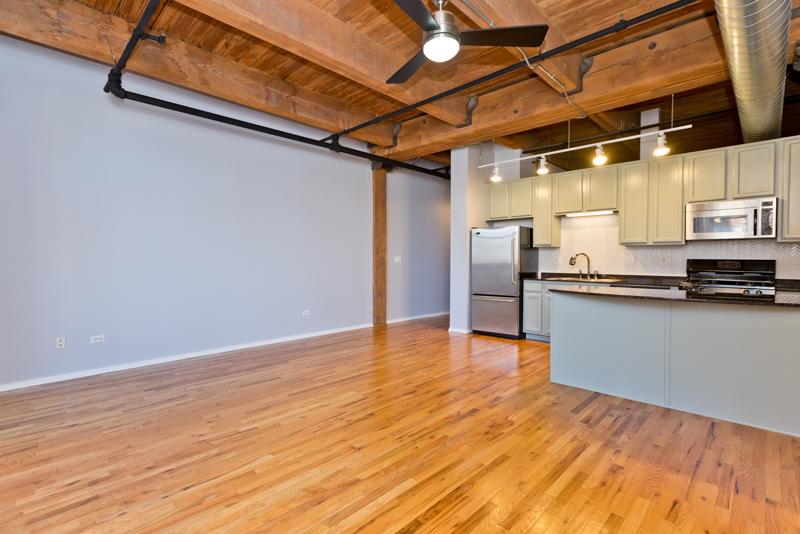 1500 West Monroe Street, Unit 515 Chicago, IL 60607 - Photo 4 of 10 a view of an empty room with wooden floor
