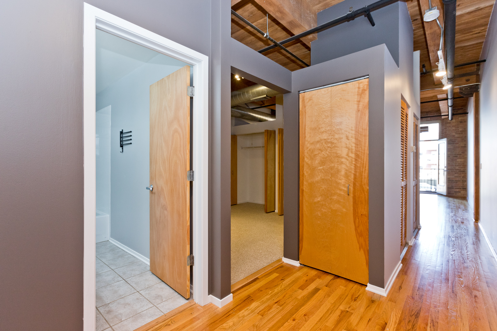 1500 West Monroe Street, Unit 515 Chicago, IL 60607 - Photo 7 of 10 a view of a hallway with wooden floor and closet