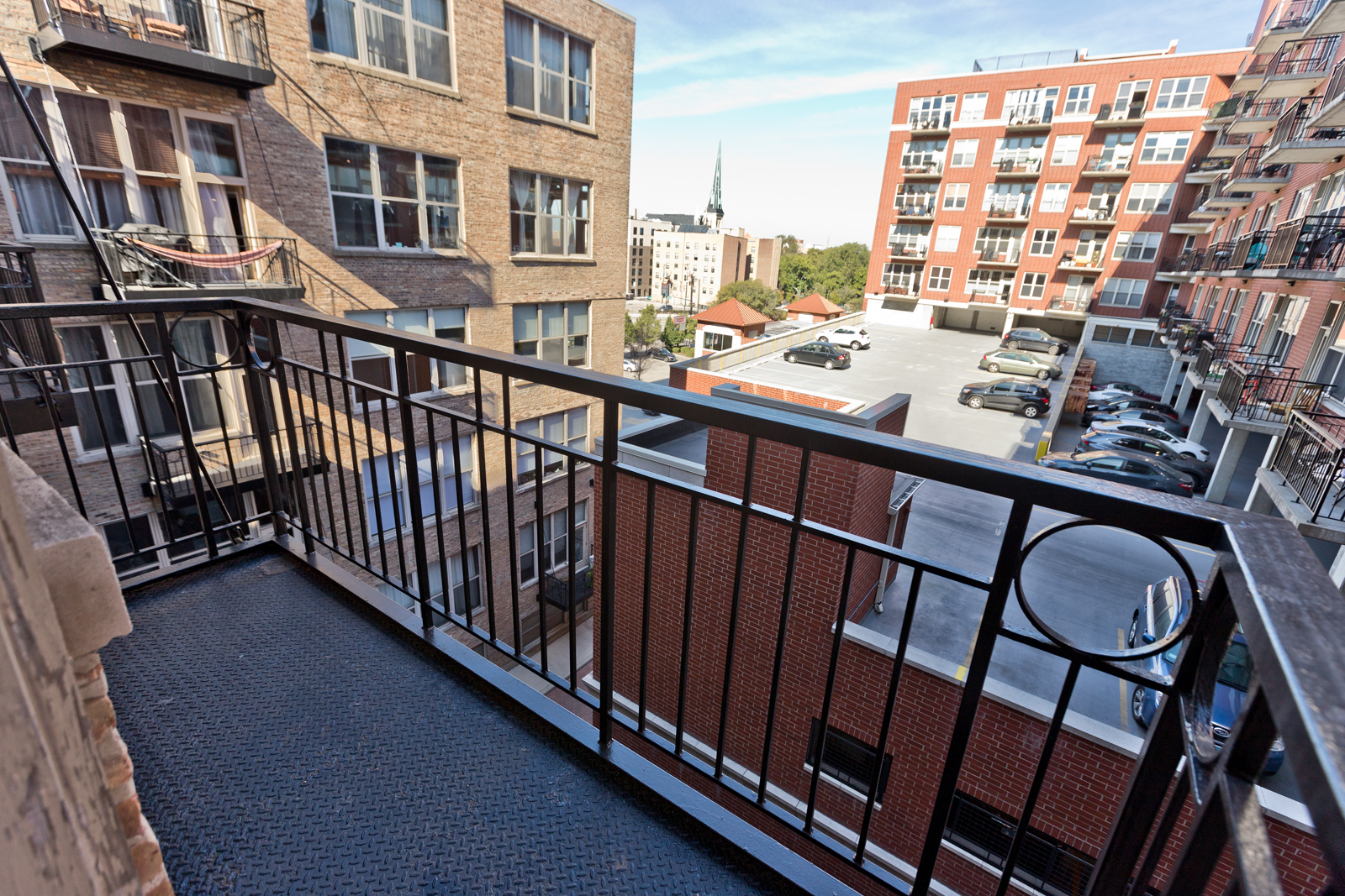 1500 West Monroe Street, Unit 515 Chicago, IL 60607 - Photo 10 of 10 a view of a balcony with a large window and wooden floor