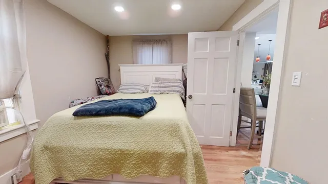 a bathroom with a toilet and a sink with a painting on the wall
