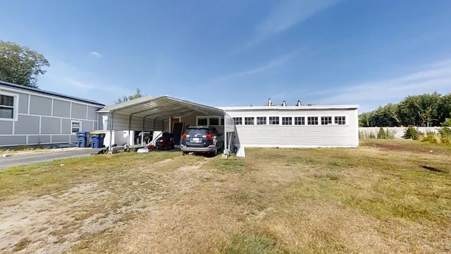 a view of a house with a swimming pool and sitting area
