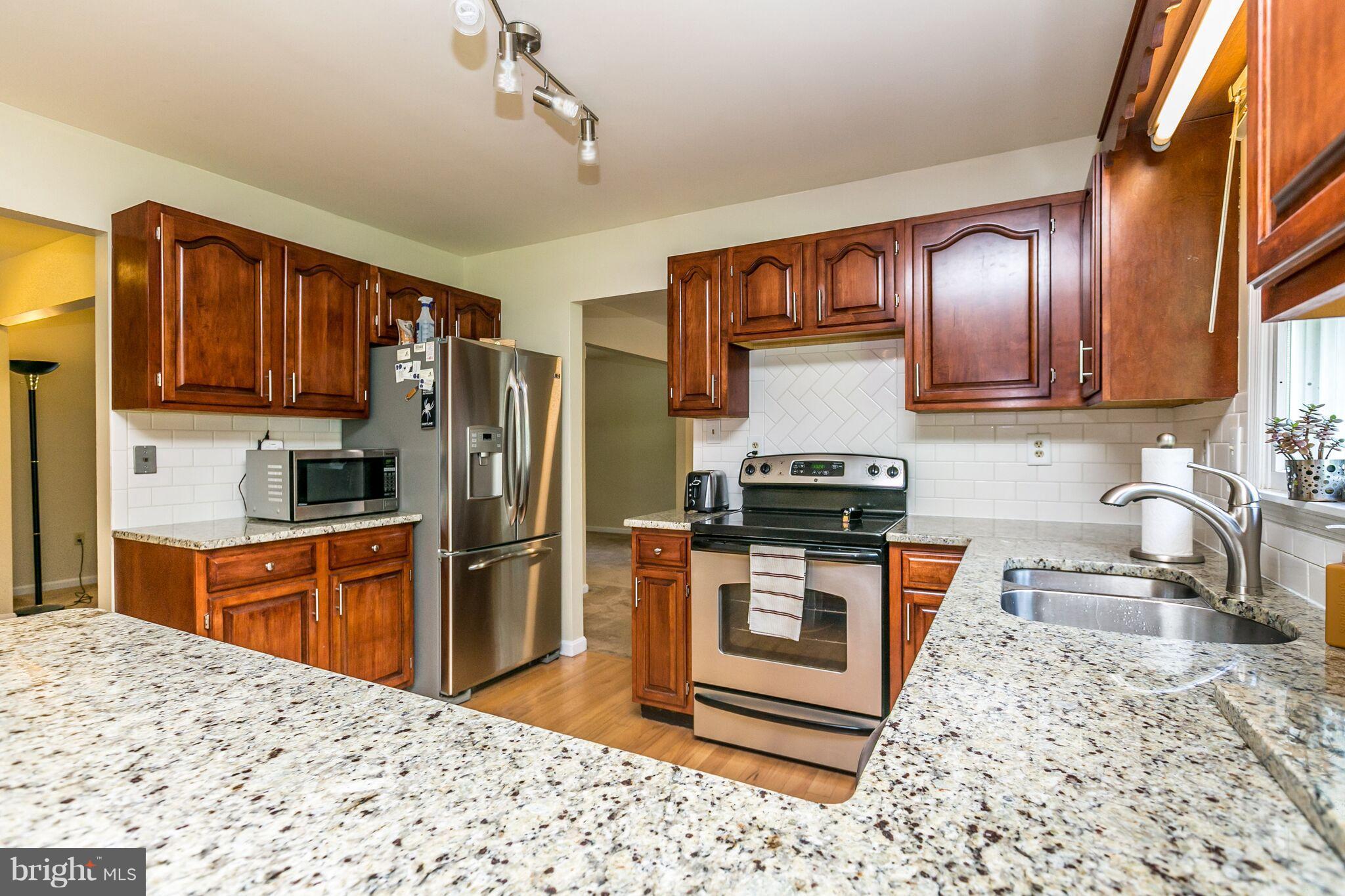 1667 Disney Road Severn, MD 21144 - Photo 10 of 28 Kitchen with granite and subway tile backsplash