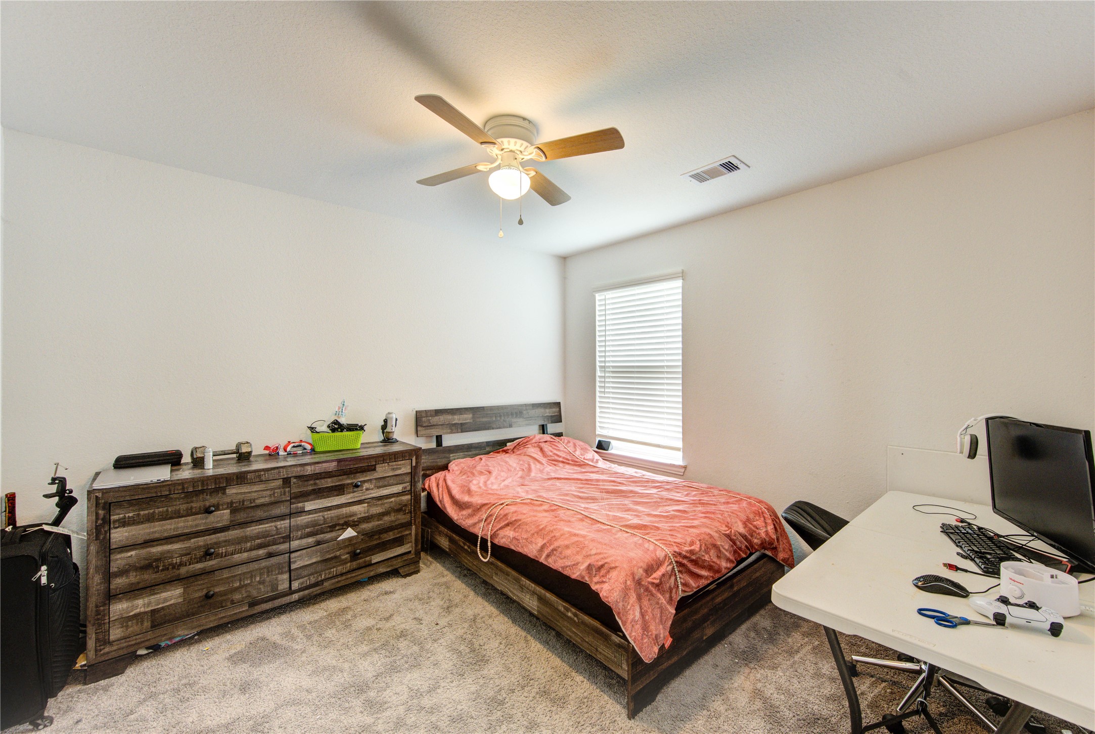 20951 New Proper Drive New Caney, TX 77357 - Photo 14 of 28 a bedroom with a bed and a chandelier