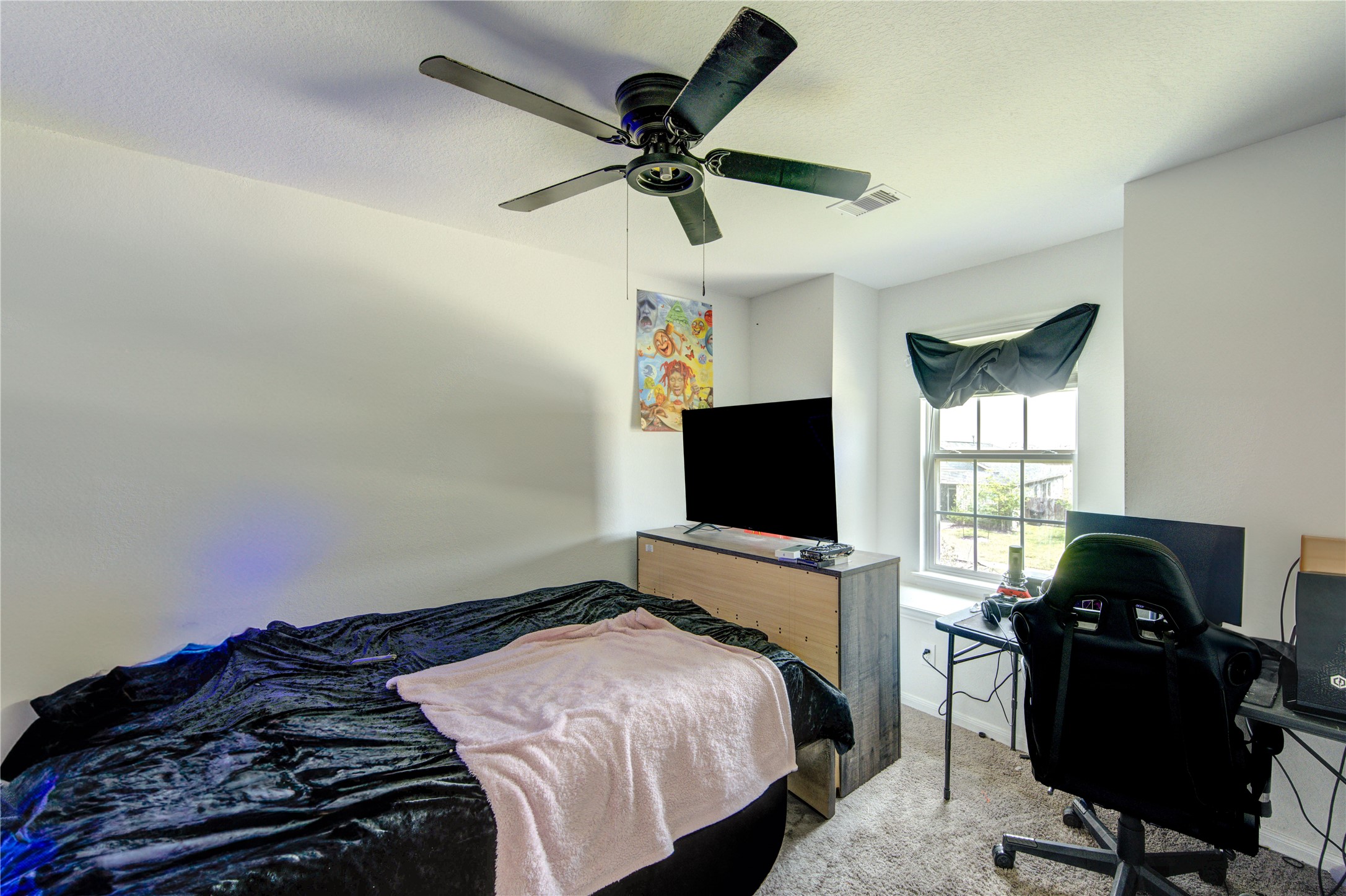 20951 New Proper Drive New Caney, TX 77357 - Photo 16 of 28 a bedroom with a bed and a flat screen tv