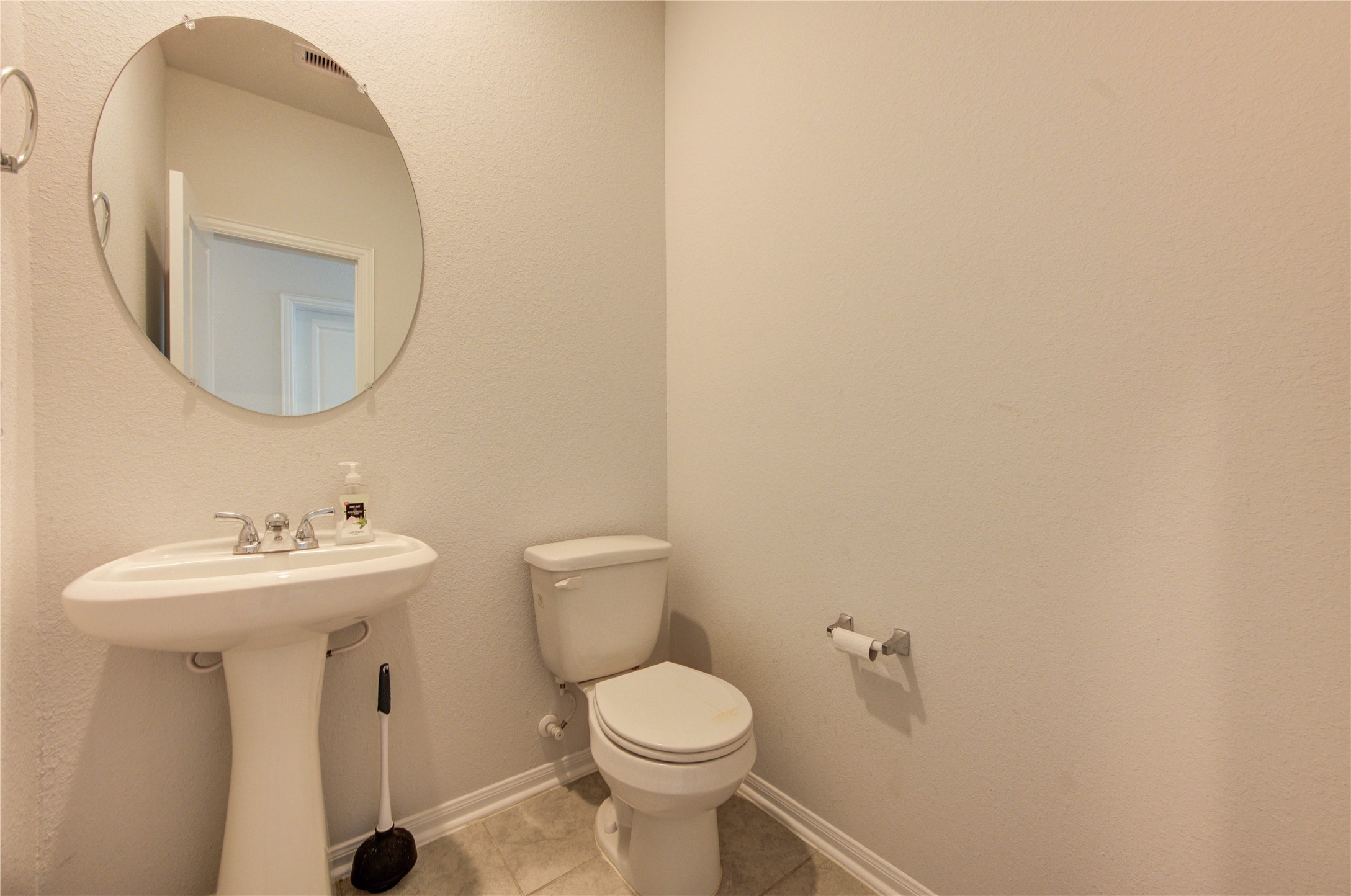 20951 New Proper Drive New Caney, TX 77357 - Photo 19 of 28 a bathroom with a toilet sink and mirror