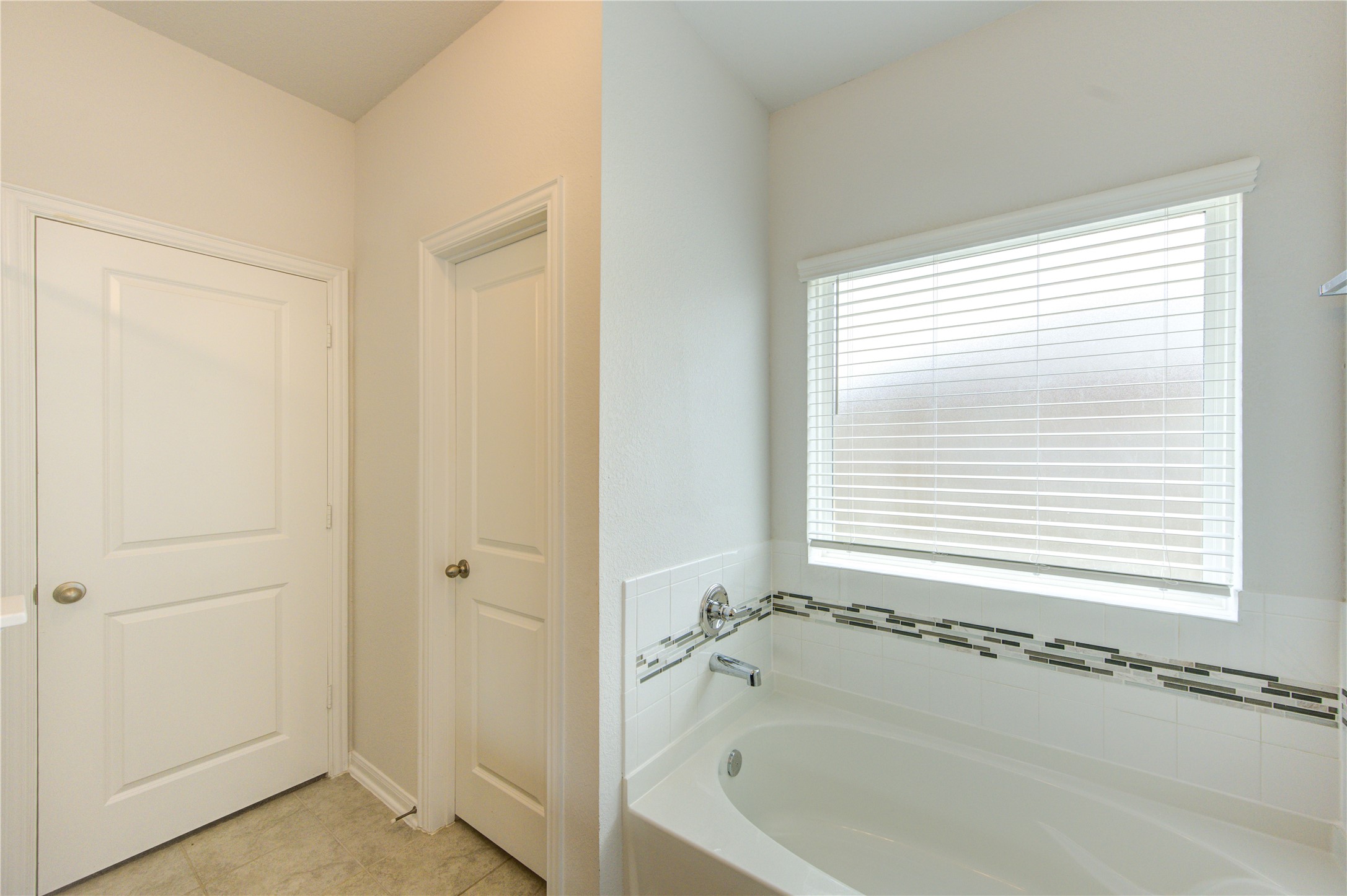 20951 New Proper Drive New Caney, TX 77357 - Photo 22 of 28 a bathroom with a bathtub next to a window