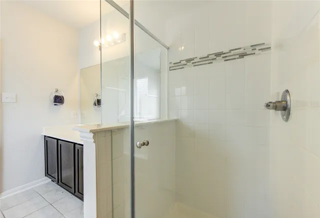 a bathroom with a shower and a glass door