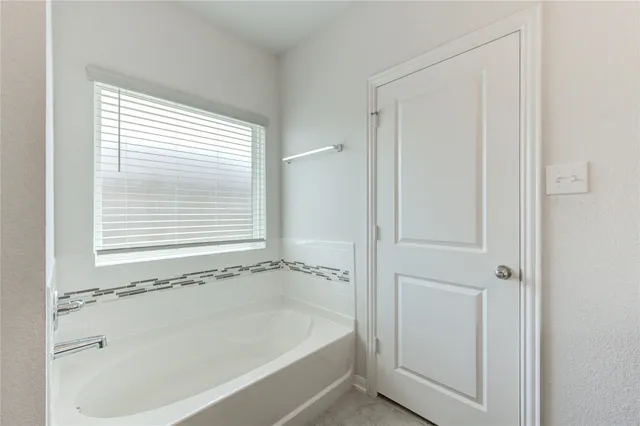 a white bath tub sitting next to a window