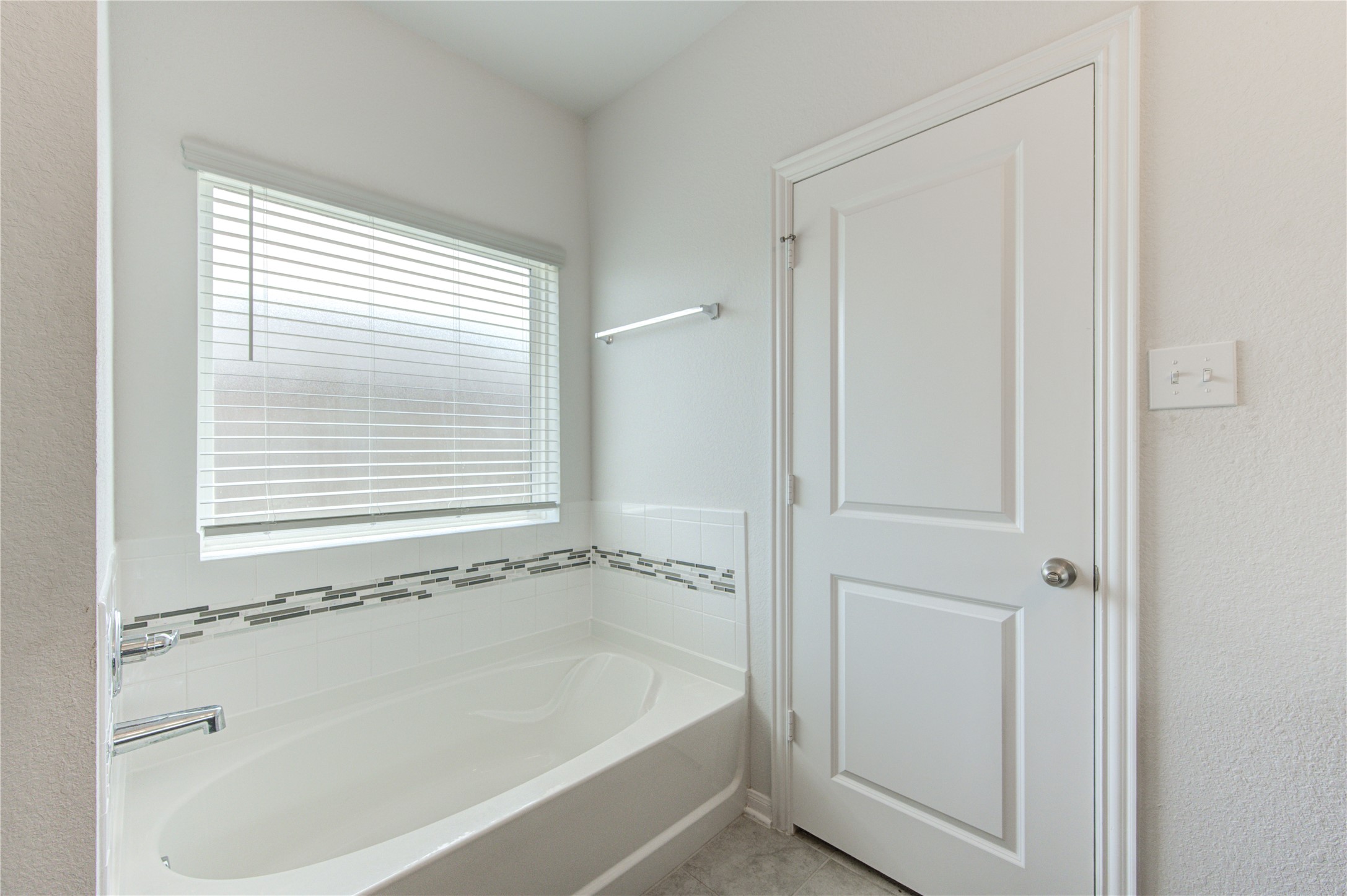 20951 New Proper Drive New Caney, TX 77357 - Photo 24 of 28 a white bath tub sitting next to a window