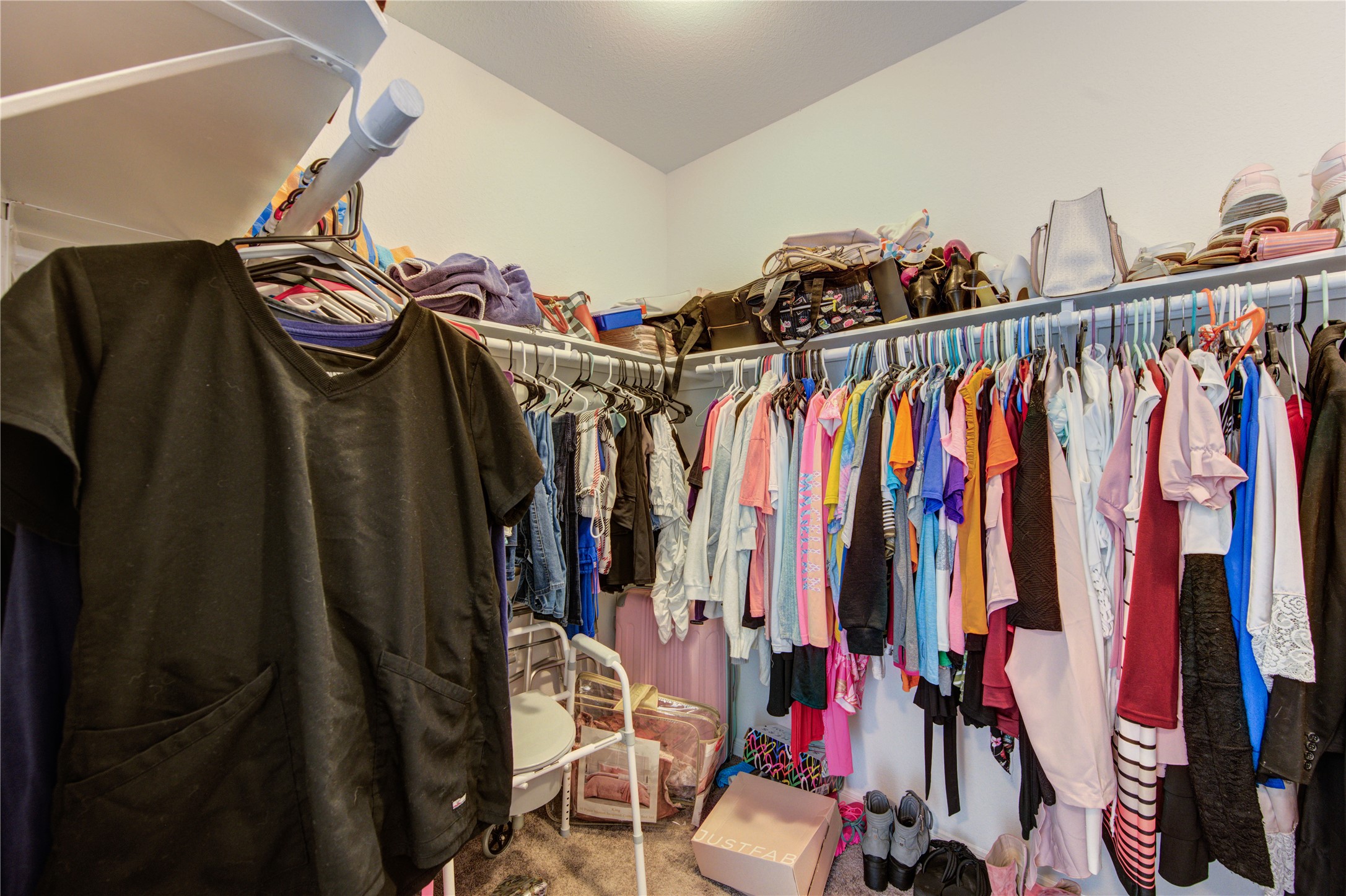 20951 New Proper Drive New Caney, TX 77357 - Photo 25 of 28 a view of walk in closet with clothes