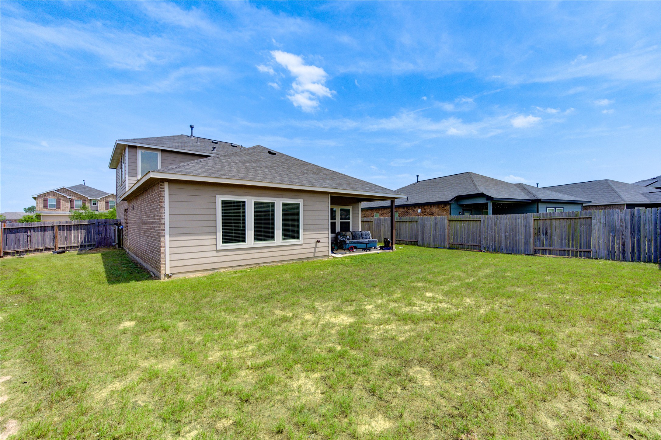 20951 New Proper Drive New Caney, TX 77357 - Photo 27 of 28 a backyard of a house with table and chairs