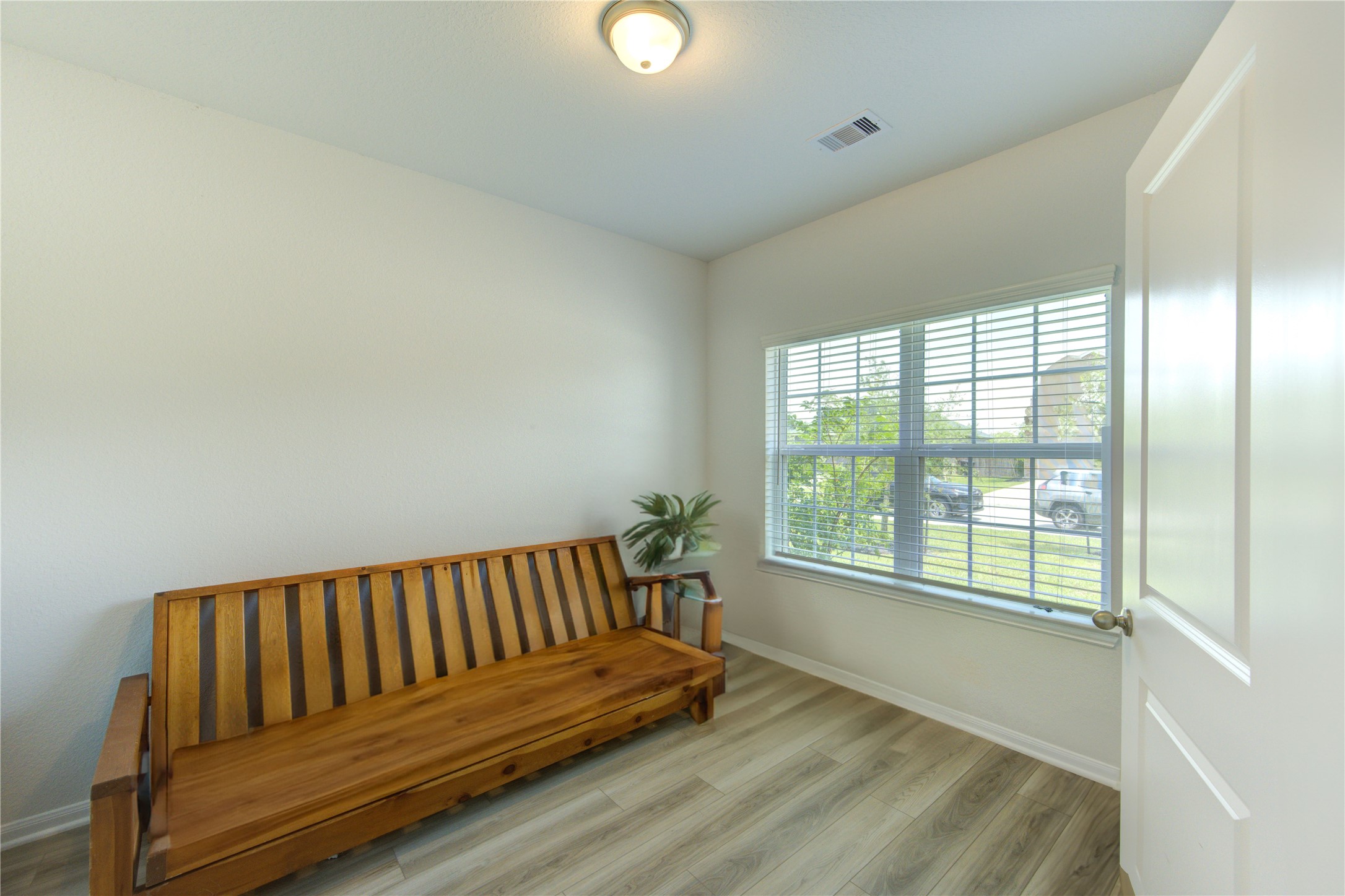 20951 New Proper Drive New Caney, TX 77357 - Photo 3 of 28 a view of a room with wooden floor and a window
