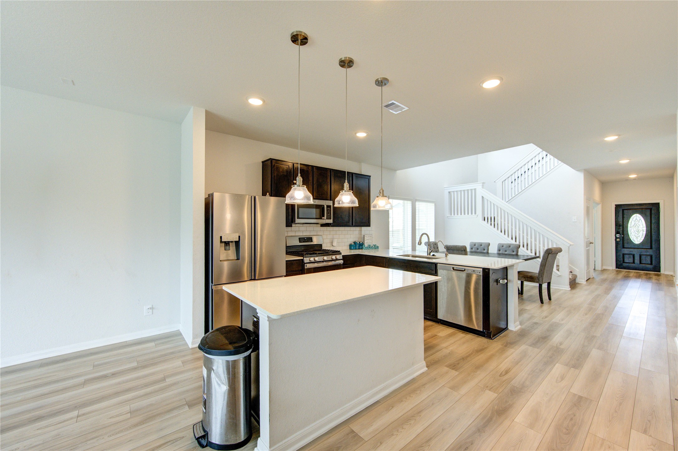 20951 New Proper Drive New Caney, TX 77357 - Photo 6 of 28 a large kitchen with stainless steel appliances a large counter top a sink a stove and a refrigerator