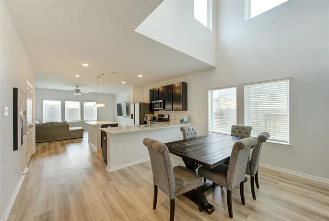 a view of a dining room with furniture window and wooden floor