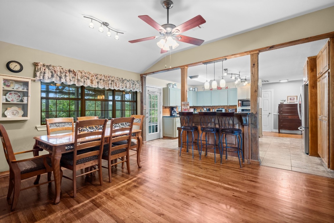 2400 Bowler Road Magnolia, TX 77355 - Photo 13 of 48 a dining room with furniture large windows and a chandelier