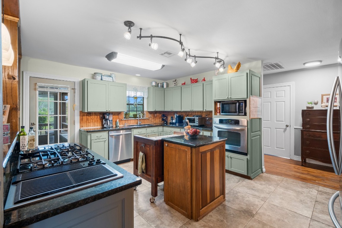2400 Bowler Road Magnolia, TX 77355 - Photo 14 of 48 a kitchen with refrigerator and stove