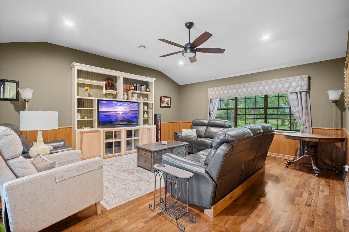 2400 Bowler Road Magnolia, TX 77355 - Photo 18 of 48 a living room with furniture and a flat screen tv with wooden floor
