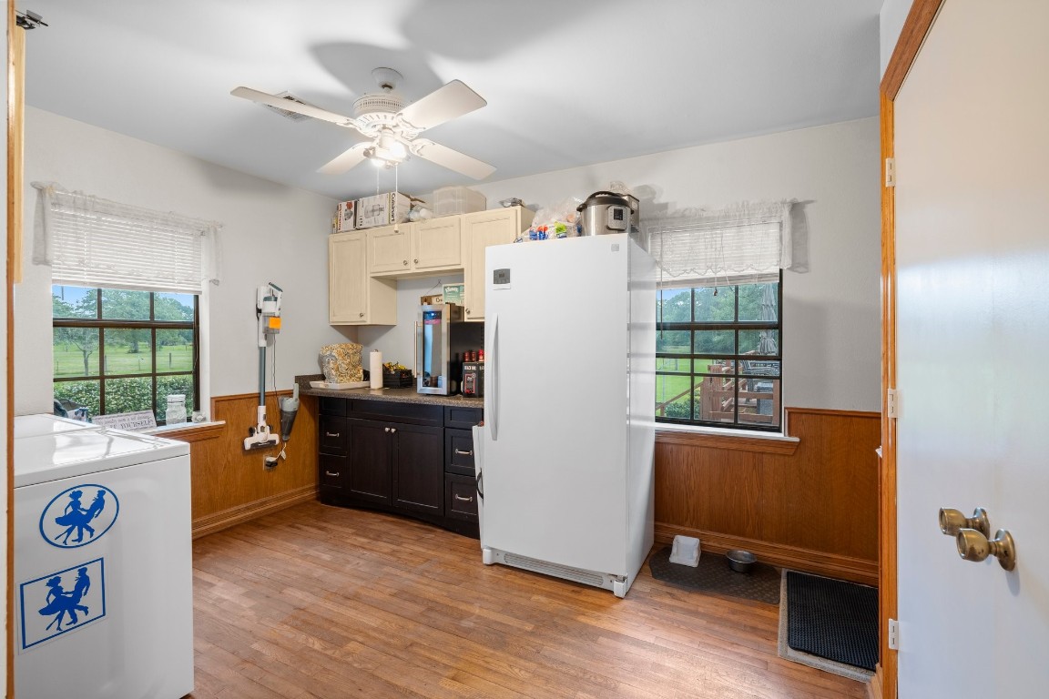 2400 Bowler Road Magnolia, TX 77355 - Photo 20 of 48 a kitchen with granite countertop a refrigerator a sink dishwasher a stove and a dining table with wooden floor