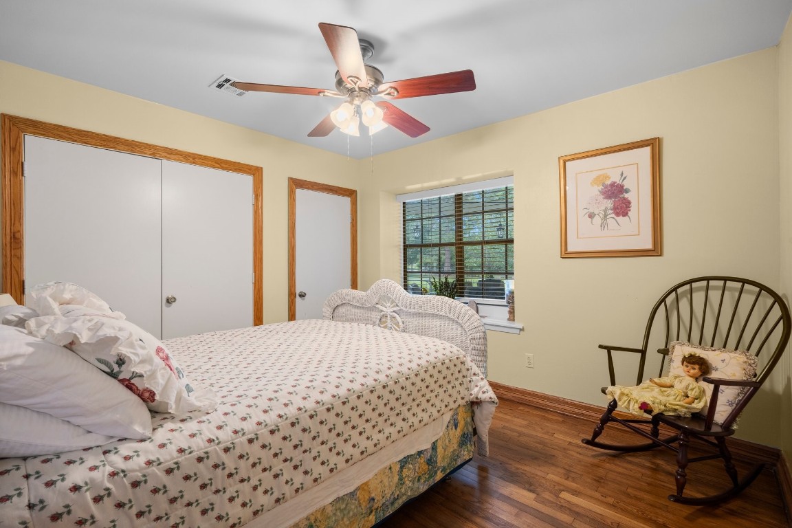 2400 Bowler Road Magnolia, TX 77355 - Photo 23 of 48 a bedroom with a bed and wooden floor
