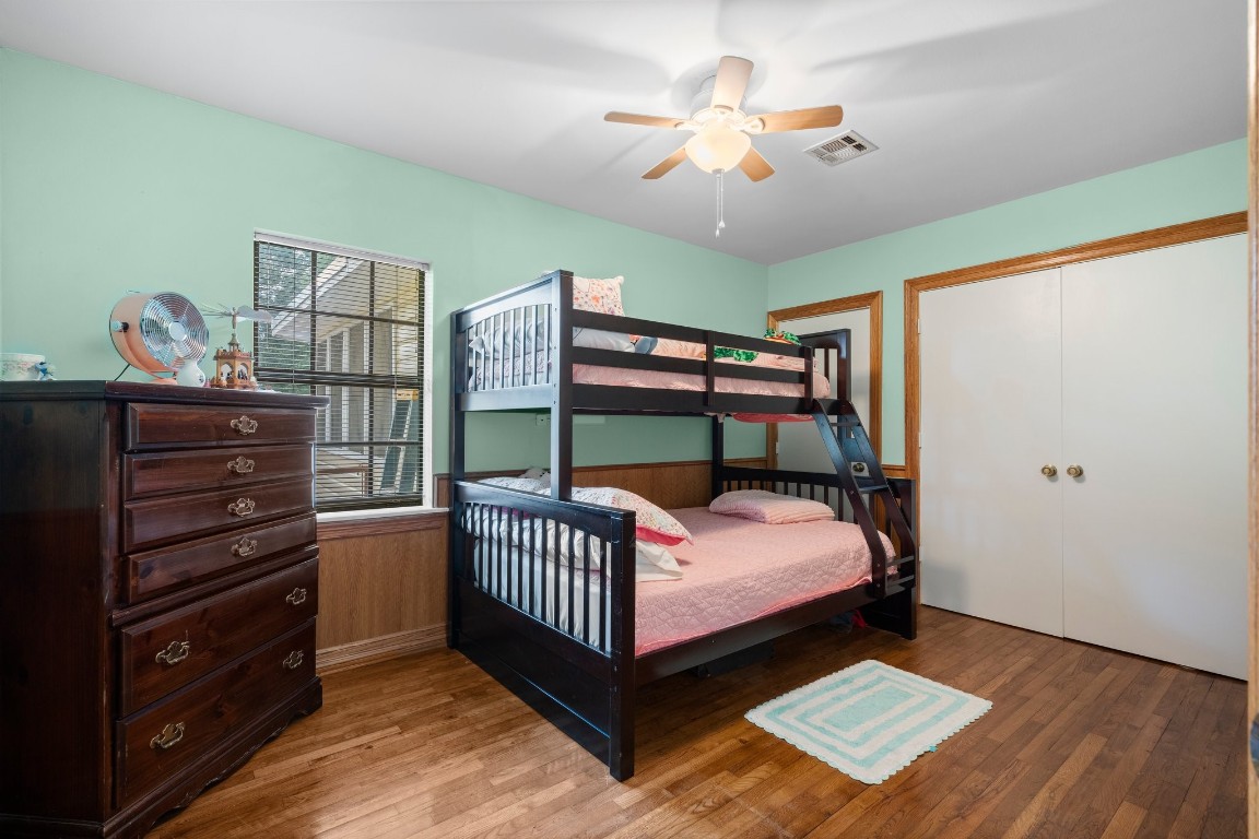 2400 Bowler Road Magnolia, TX 77355 - Photo 24 of 48 a bedroom with a bed and a chandelier