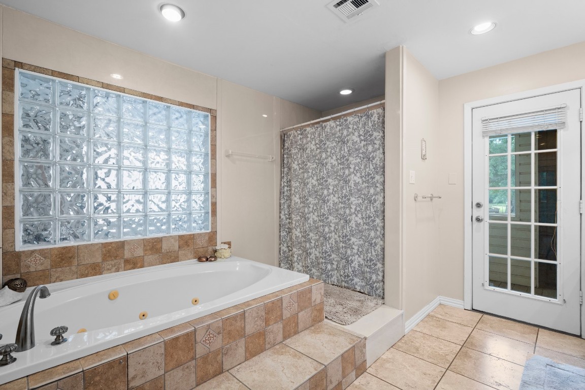 2400 Bowler Road Magnolia, TX 77355 - Photo 28 of 48 a bathroom with a bathtub and a shower