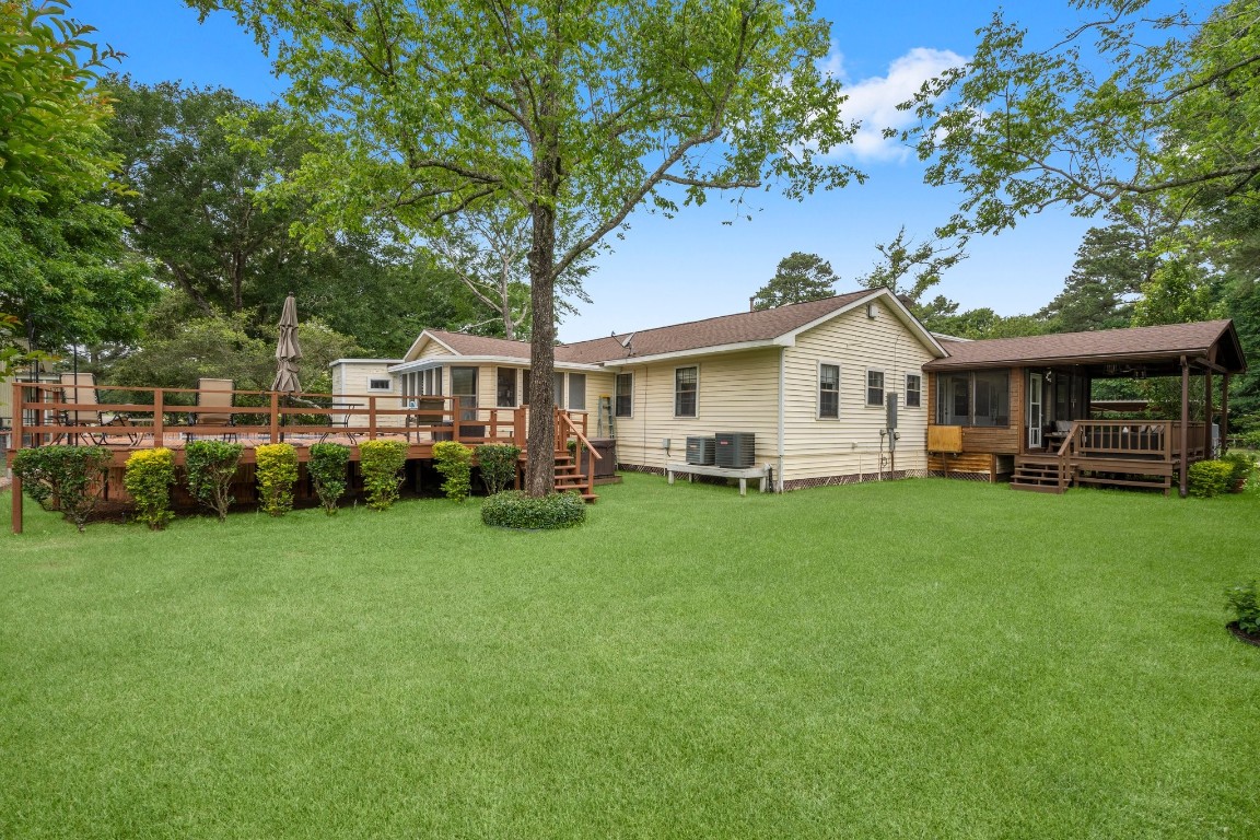 2400 Bowler Road Magnolia, TX 77355 - Photo 32 of 48 a view of a house with a backyard