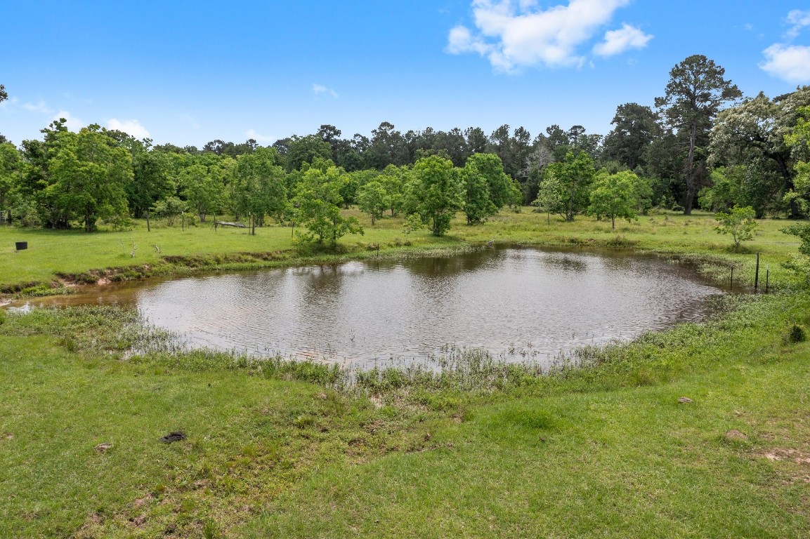 2400 Bowler Road Magnolia, TX 77355 - Photo 35 of 48 a view of a lake with a yard and mountain view