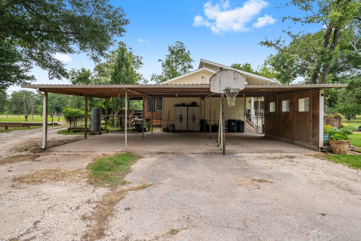 2400 Bowler Road Magnolia, TX 77355 - Photo 9 of 48 a view of a house with backyard and a patio