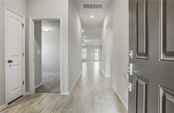 a view of a hallway with wooden floor