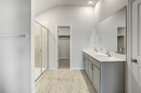 a bathroom with a double vanity sink and mirror