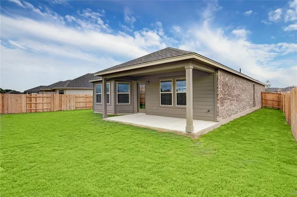 a view of a house with a backyard