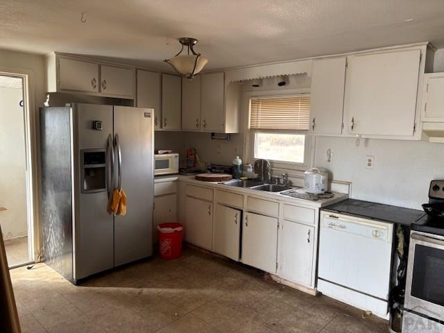 490 A Street Penrose, CO 81240 - Photo 18 of 46 a kitchen with stainless steel appliances granite countertop a refrigerator a sink and white cabinets