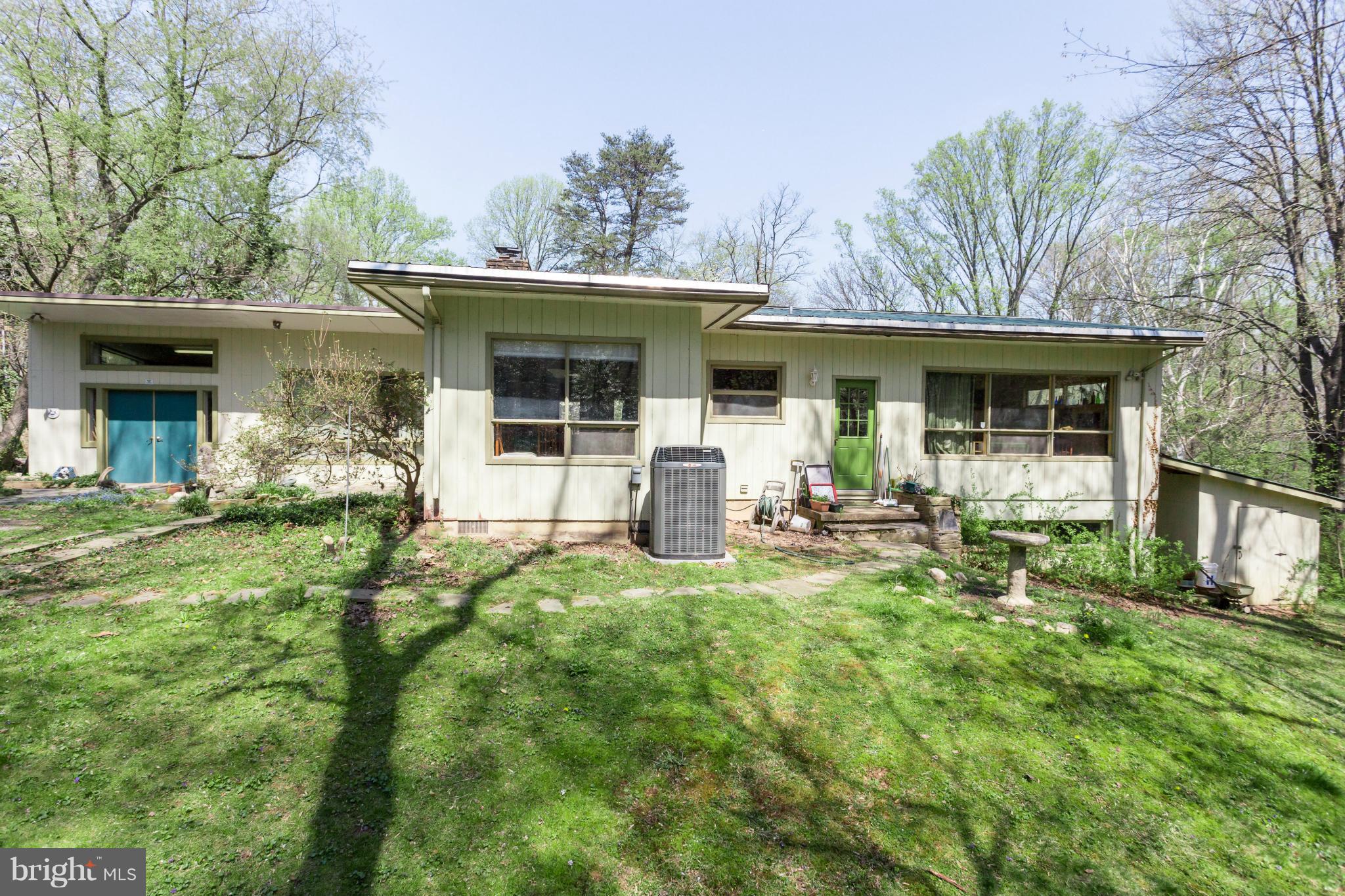 1780 Proffit Road Vienna, VA 22182 - Photo 19 of 21 a view of a house with backyard sitting area and garden
